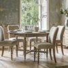 handcrafted extendable oak round dining table seating six people with decorative bobbin legs