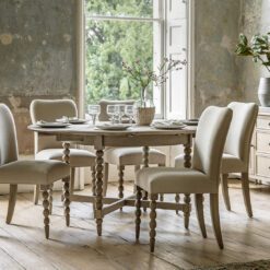 handcrafted extendable oak round dining table seating six people with decorative bobbin legs