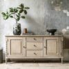 handcrafted oak sideboard with two shelved cupboards and three drawers, bobbin turned legs and a lime wash finish