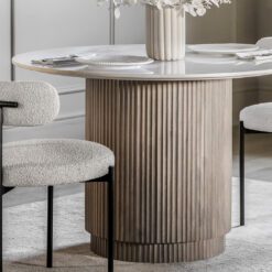 round dining table with a ribbed, drum shaped, base crafted from mango wood and topped with Indian white marble