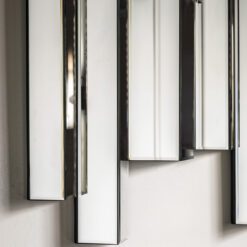 bevelled mirror panels combine with a modern design to complete this glass art deco style wall mirror with silver edging