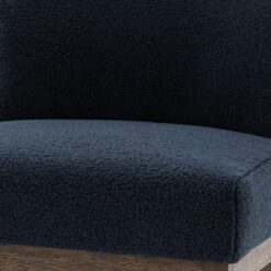 small oak framed occasional chair with a curved back upholstered in a cosy textured deep blue fabric