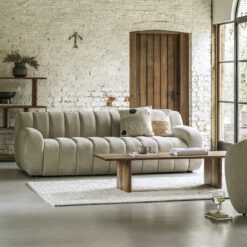 large three-seater retro-inspired contemporary cream sofa with a curved design and wide ribbing