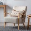 oak framed occasional armchair with curved arms, upholstered in a natural linen
