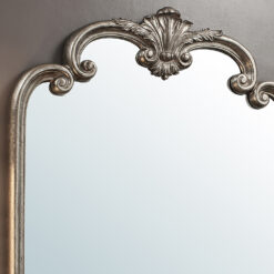 large decorative overmantle wall mirror with ornate detailing and a silver leaf finish