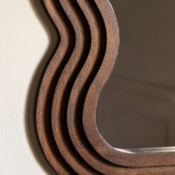 deep wooden framed wall mirror with a distinctive layered wavy edging and rich dark brown finish