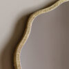 decorative full length leaner mirror with a wavy silm metal frame finished in gold leaf