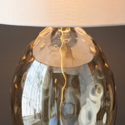 large oval glass table lamp with a textured dimpled champagne glass base, satin brass accents and a natural drum lampshade
