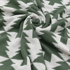 cosy green and cream knitted throw with a bold christmas tree pattern and green tassels