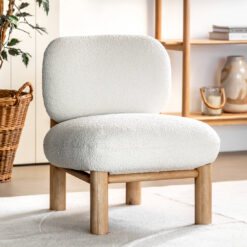 contemporary scandi-inspired occasional chair with a chunky wooden frame and cream boucle deep seat and back rest