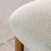 contemporary scandi-inspired occasional chair with a chunky wooden frame and cream boucle deep seat and back rest