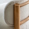 contemporary scandi-inspired occasional chair with a chunky wooden frame and cream boucle deep seat and back rest