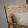 colonial inspired occasional chair crafted from ash with a limewash finish, rattan detailing and natural cushions