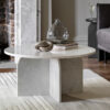 handcrafted modern round white solid marble coffee table showcasing individual veining and a sleek arched base
