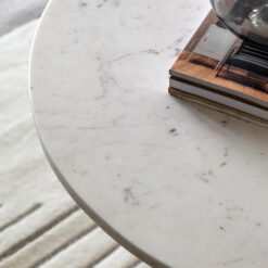 handcrafted modern round white solid marble coffee table showcasing individual veining and a sleek arched base