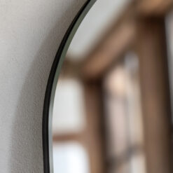 slim arched full-length wall mirror with a slim metal frame and matt black finish