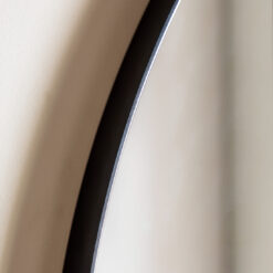 large arched overmantle wall mirror with a slim metal frame finished in matt black