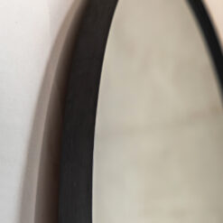 large oversized arched leaner mirror with a slim metal matt black frame