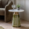 round side table with a fluted glass pedestal base finish in olive green with brass accents and complete with a round white marble tabletop with subtle veining