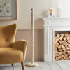 stick metal floor lamp base with bobbin detailing finished in a creamy vintage white and matching fabric cord