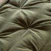 luxurious olive green velvet bedspread with a pintucked quilted design and natural cotton and linen blend reverse