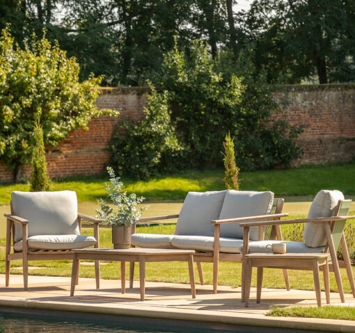 five piece outdoor garden sofa lounge set blending Scandi design and natural textures - two seater sofa, two armchairs both with grey cushions, coffee table and side table with grey
