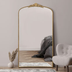 oversized large wall mirror with a decorative slim frame, arched top and ornate crown finished in a warm gold