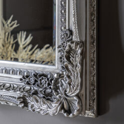 statement rectangular wall mirror with a decorative baroque frame finished in silver