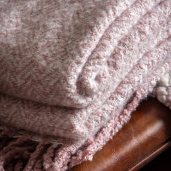 blush pink soft throw with a herringbone design and long fringing