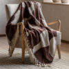 cosy chenille throw with a chocolate brown and cream abstract patter and long, soft cream tassel edging