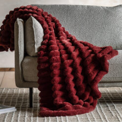 soft, luxurious, faux fur chunky throw with a ribbed design in a deep red